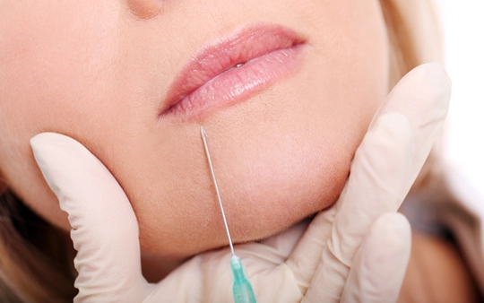 Cosmetic Surgery Dermal Fillers Injection Treatment in Gandhipuram A plastic surgeon performs cosmetic surgery and dermal filler injection treatment on a patient in Gandhipuram